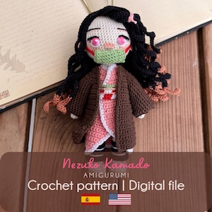 May include: A handmade crochet amigurumi doll of Nezuko Kamado with long black hair, pink eyes, and a green bamboo muzzle. The doll wears a pink kimono with a white and red obi sash under a brown haori jacket. Text reads: Nezuko Kamado AMIGURUMI Crochet pattern | Digital file.