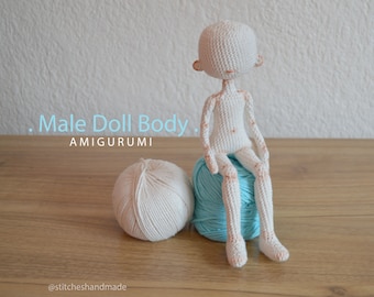 May include: White crocheted amigurumi doll body sitting on a blue yarn ball. The doll has a simple face and is sitting with its legs crossed. The text "Male Doll Body" and "AMIGURUMI" is visible in the image. The text "@stitcheshandmade" is visible at the bottom of the image.