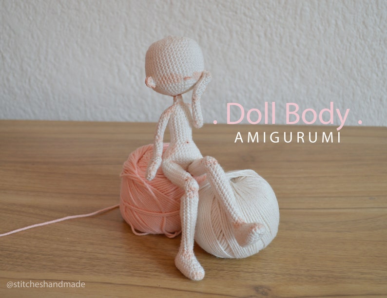 May include: White crocheted amigurumi doll body sitting on two balls of yarn, one pink and one white. The doll is sitting with its legs crossed and its right hand on its cheek. The text "Doll Body. AMIGURUMI" is written in pink letters on a white background.