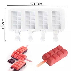May include: White silicone popsicle mold with four compartments, each with a waffle pattern. The mold measures 21.1 inches by 12.2 inches. There are four wooden popsicle sticks and three pink popsicles with a waffle pattern.