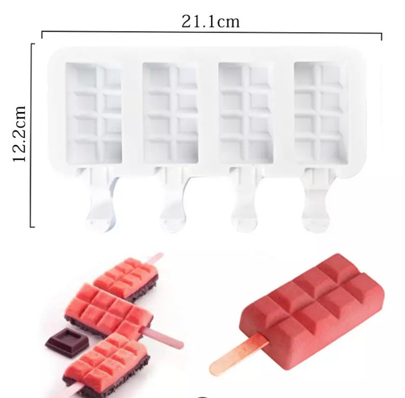 May include: White silicone popsicle mold with four compartments, each with a waffle pattern. The mold measures 21.1 inches by 12.2 inches. There are four wooden popsicle sticks and three pink popsicles with a waffle pattern.