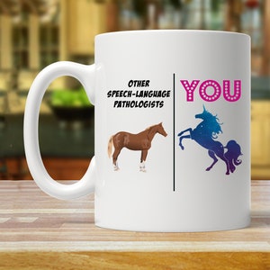 May include: White ceramic mug with a humorous design comparing other speech-language pathologists to a horse and the user to a unicorn. The text reads "Other Speech-Language Pathologists" and "You".