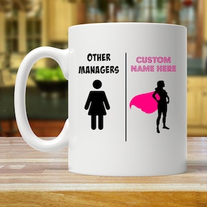 May include: White ceramic mug with a black silhouette of a woman on the left side and the text "OTHER MANAGERS". On the right side is a black silhouette of a woman wearing a pink cape with the text "CUSTOM NAME HERE".