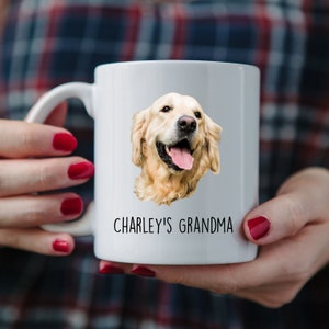 May include: White ceramic mug with a picture of a golden retriever dog and the text "CHARLEY'S GRANDMA" printed on it.