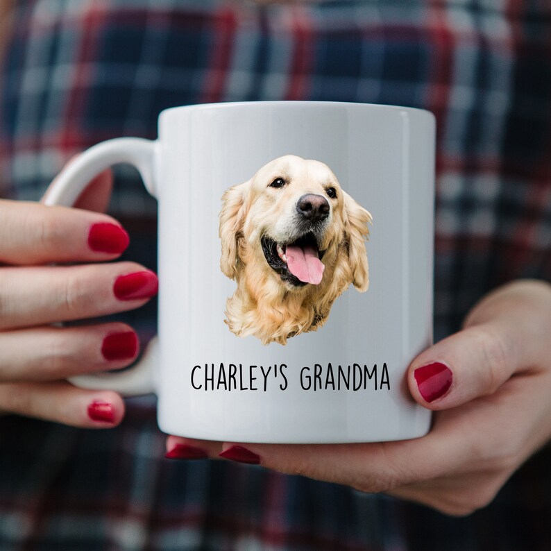 May include: White ceramic mug with a picture of a golden retriever dog and the text "CHARLEY'S GRANDMA" printed on it.
