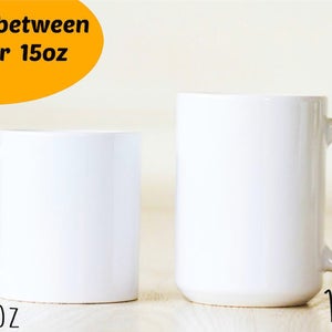 May include: Two white ceramic mugs, one 11 oz and one 15 oz, side by side on a light wood surface. Choose between 11oz or 15oz.