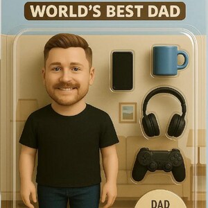 May include: A figurine of a man in a black t-shirt and blue jeans, with the text "DANIEL WORLD'S BEST DAD". Accessories include a phone, mug, headphones, and game controller. "DAD ACCESSORIES INCLUDED" is also printed on the packaging.
