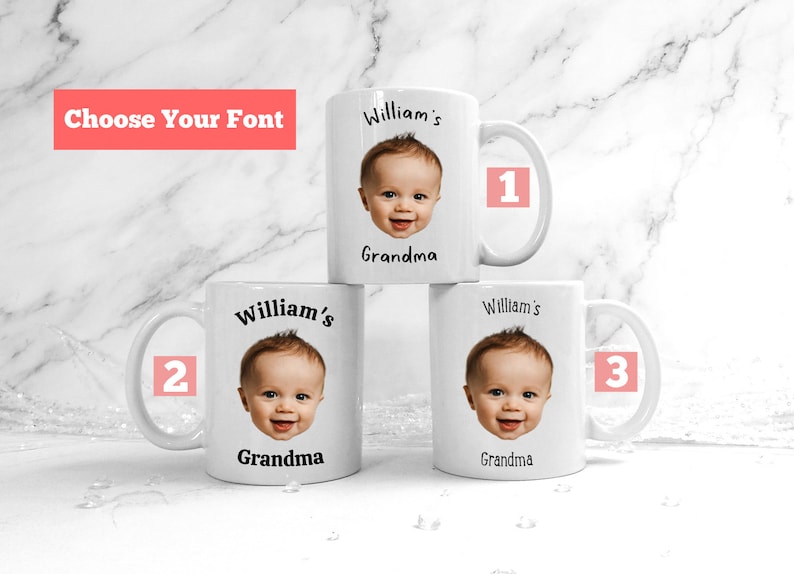 May include: Three white ceramic mugs with a baby's face printed on them. The mugs have black text that reads "William's Grandma" and are numbered 1, 2, and 3.