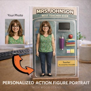 May include: A personalized action figure portrait of a teacher, displayed in a clear case with a wood stand. The figure is wearing glasses, a floral top, and jeans. Accessories include a laptop, tumbler, apple, books, and sticky notes. The text reads "MRS. JOHNSON BEST TEACHER EVER."