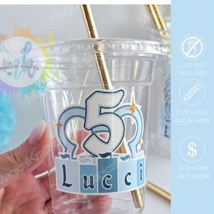 May include: A clear plastic cup featuring a custom sticker with the number 5 in light blue, the name Lucci in dark blue, and gold star accents. The sticker is applied to the front of the cup, which contains a gold straw. Text includes STICKERS ONLY.