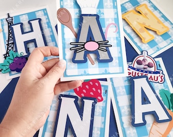 May include: A collection of handmade paper cutouts featuring letters, food, and chef-themed elements. The letter "A" is adorned with a chef's hat, a wooden spoon, and a mouse face. Other letters and food items are also visible.