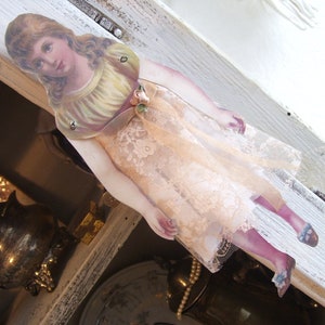 Victorian paper figure pendant...child...with lace dress...the arms and legs are movable...extraordinarily beautiful
