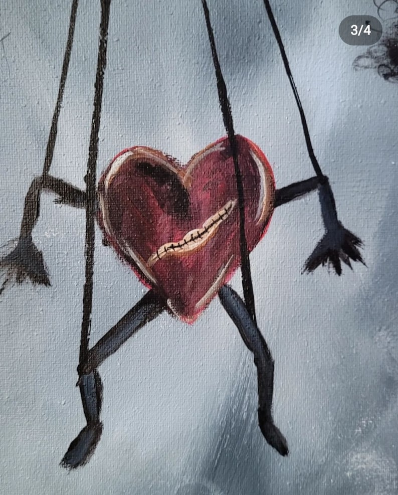 Pu&ograve; includere: Un burattino a forma di cuore rosso con labbra cucite e arti neri &egrave; sospeso da delle corde su uno sfondo blu chiaro.