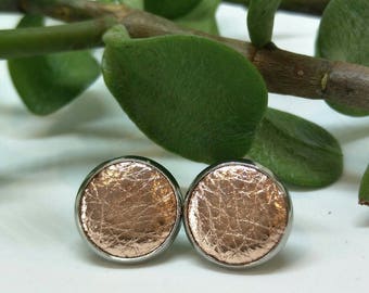 Leather studs in rose gold print. Hypoallergenic surgical stainless steel bezel.