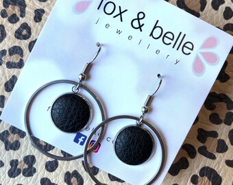 Dangle earrings featuring a 3cm hoop and 14mm black leather bezel. Surgical stainless steel. All hypoallergenic.