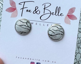 Leather studs in metallic wave print. Hypoallergenic surgical stainless steel bezel. Silver studs. Metallic studs.