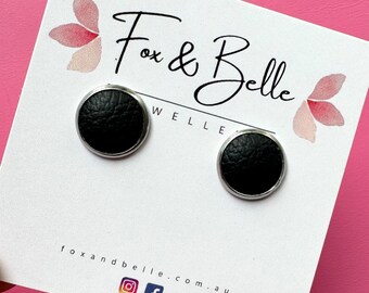 Leather studs in black beauty print. Hypoallergenic surgical stainless steel bezel. Black stud earrings. Black leather earrings.