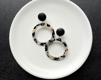 Leather dangle earrings in black swirl resin with black leather stud. Stainless steel post. Hypoallergenic. Light weight.