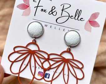 Rust floral dangle earrings with 10mm white leather stud. Hypoallergenic stainless steel. Rust dangle earrings. Butterfly back.
