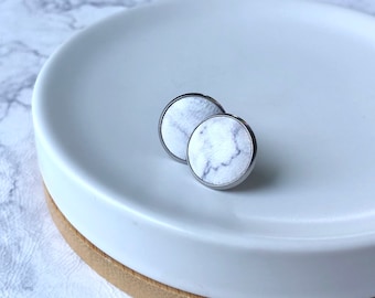 Leather studs in Marble print. Hypoallergenic surgical stainless steel bezel.