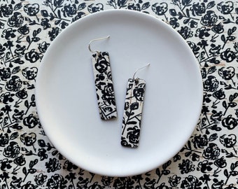 Cork earrings with leather backing- Bar design in black and white floral print. Hypoallergenic sterling silver hooks. Light weight earrings.