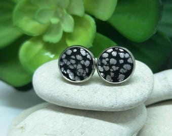 Leather studs in black with silver spots print. Hypoallergenic surgical stainless steel bezel.