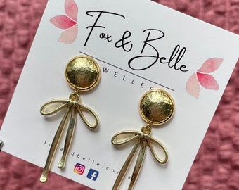 Leather dangle earrings- gold bow with gold leather stud. Stainless steel post. Hypoallergenic. Light weight earring. 12mm stud. Gold dangle