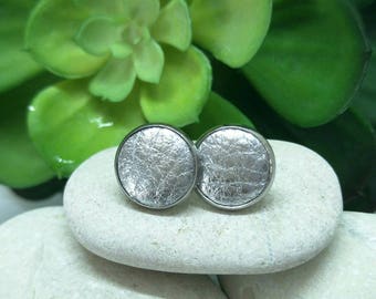 Leather studs in silver print. Hypoallergenic surgical stainless steel bezel.