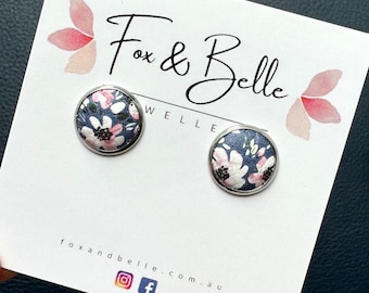 Leather studs in pink petal print. Pink and navy studs. Floral studs. Flower studs. Hypoallergenic surgical stainless steel bezel.