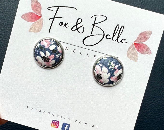 Featured listing image: Leather studs in pink petal print. Pink and navy studs. Floral studs. Flower studs. Hypoallergenic surgical stainless steel bezel.