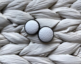Black leather Studs in white. Hypoallergenic surgical stainless steel bezel.