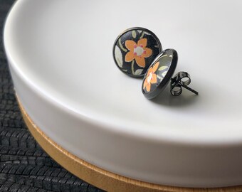Black leather Studs with orange flowers. 12mm. Hypoallergenic surgical stainless steel bezel.