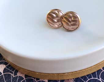 Rose Gold Leather studs in rose gold braided. Hypoallergenic surgical stainless steel bezel.