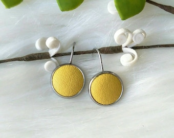 Leather Drop Studs in buttercup yellow print. Hypoallergenic surgical stainless steel bezel.