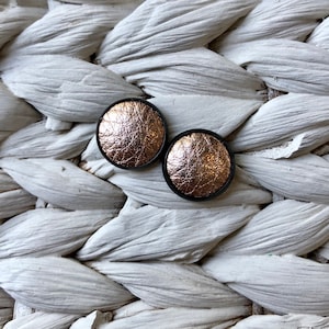 Black leather Studs in rose gold. Hypoallergenic surgical stainless steel bezel.