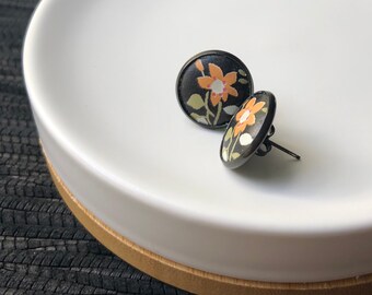 Black leather Studs with orange flowers. 14mm. Hypoallergenic surgical stainless steel bezel.