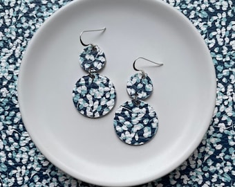 Leather dangle earrings in blue flowers. Double leather circles. Sterling silver hooks. Hypoallergenic. Light weight earring.