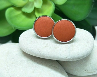 Leather studs in persimmon orange print. Hypoallergenic surgical stainless steel bezel.