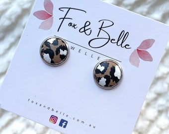 Leather studs in wild thing leopard print. Hypoallergenic surgical stainless steel bezel. Leopard studs. Animal studs.