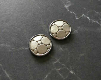 Leather studs in platinum mosaic print. Hypoallergenic surgical stainless steel bezel.
