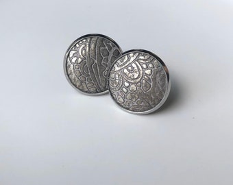 Leather studs in antique silver print. Hypoallergenic surgical stainless steel bezel.