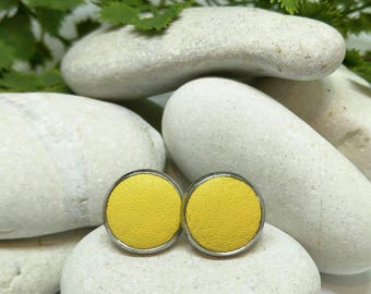 Leather studs in buttercup yellow print. Hypoallergenic surgical stainless steel bezel.