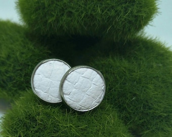 Leather studs in snow white print. Hypoallergenic surgical stainless steel bezel.