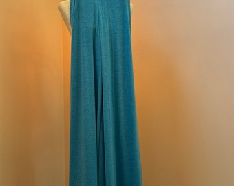 May include: A pair of light blue wide-leg pants hanging on a wooden hanger.