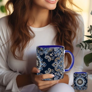 May include: A blue and gold ceramic mug with a floral pattern. The mug has a blue rim and handle.