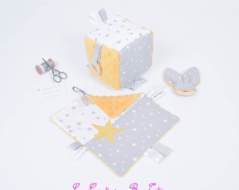 Box, Montessori-inspired games, awakening cube, natural wood teething ring and matching grey, white and mustard yellow blanket