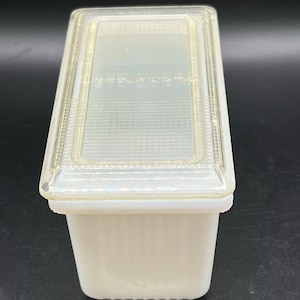 May include: White rectangular glass storage container with a clear plastic lid. The lid has a grid pattern and the words "Keep-Fresh" printed on it.