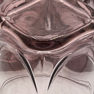 May include: A clear glass vase with a textured, wavy design. The vase is a deep purple color and has a gradient effect, fading to a lighter shade at the bottom.