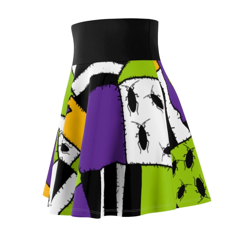 May include: A black, green, purple, white, and yellow patchwork skirt with a black waistband and a pattern of bugs.