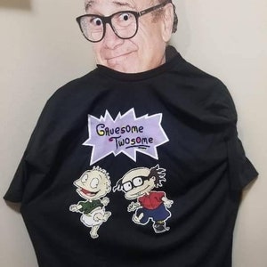May include: Black t-shirt with a cartoon graphic of two characters from the Nickelodeon show Rugrats. The graphic says "Gruesome Twosome" in a purple speech bubble.